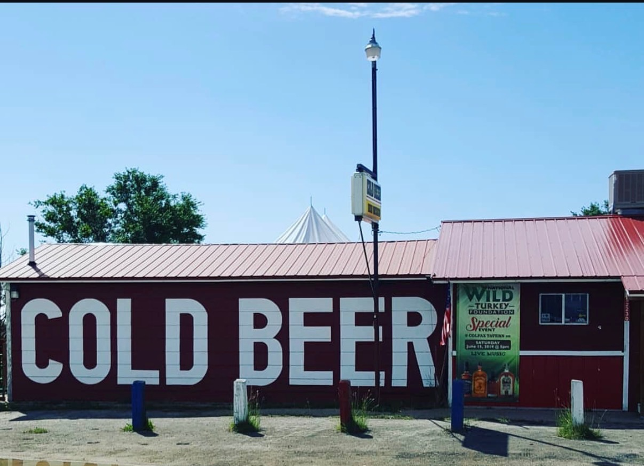 Cold Beer NM · full facade · giant lettering · red wall · open plains