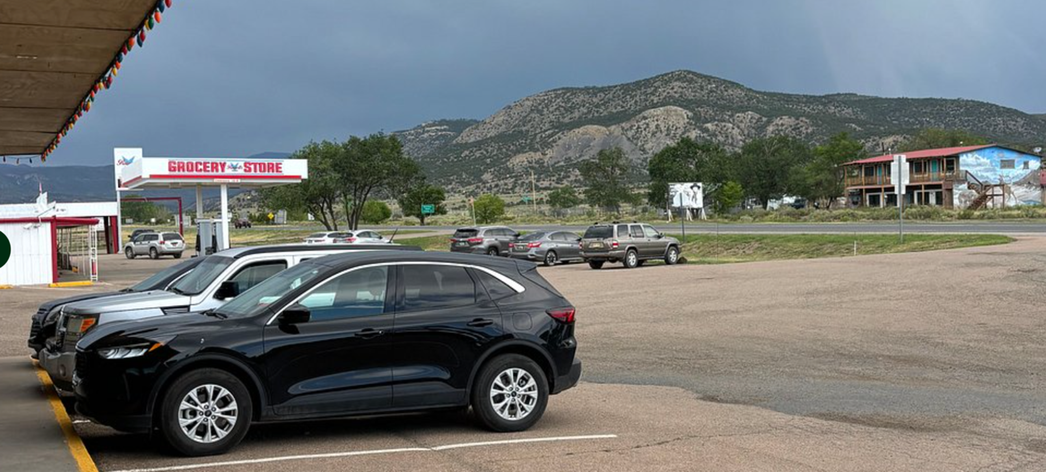 Cree-Mee Drive-In · parking lot · Cimarron Range · storm clouds