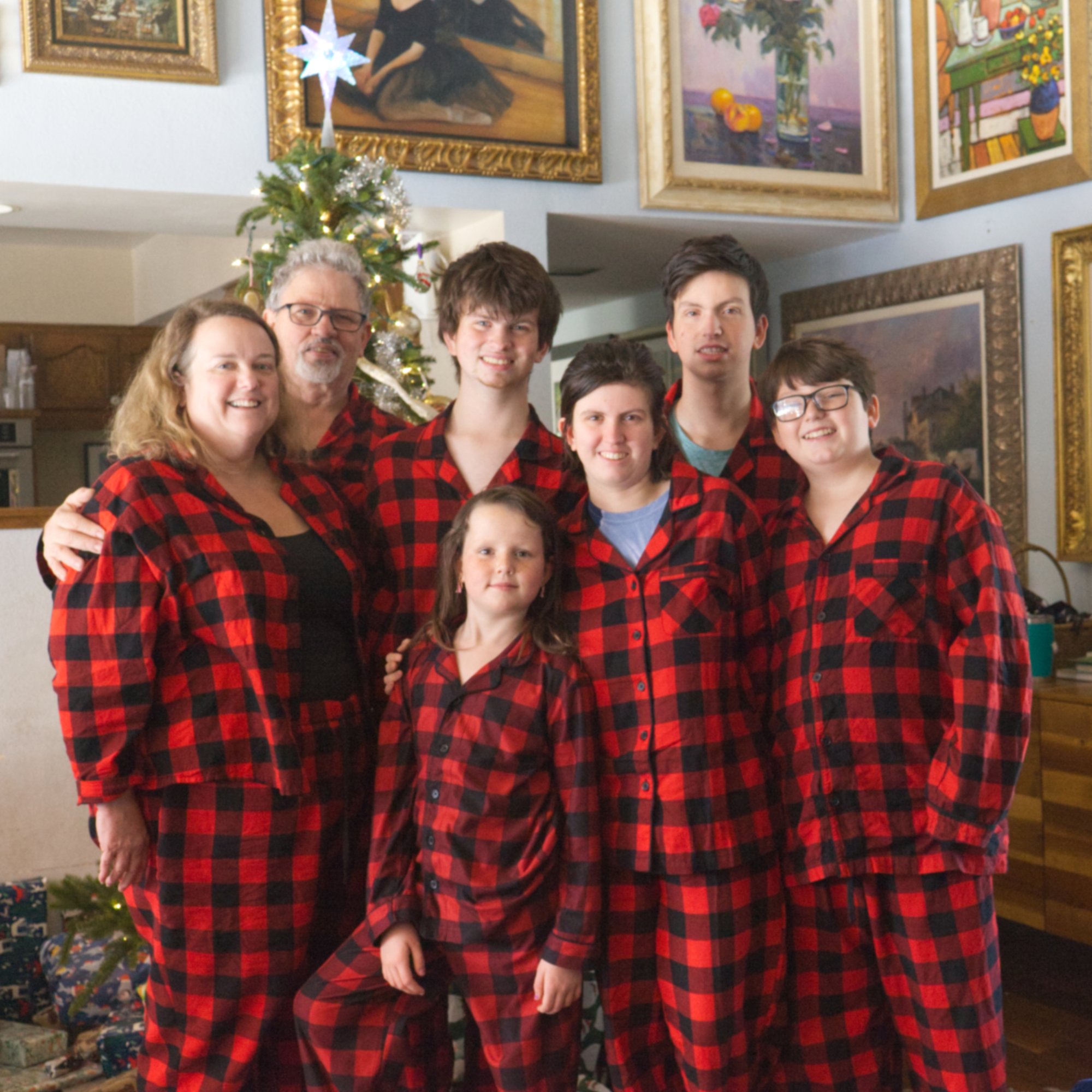 The Jennings family Christmas 2022 · matching red plaid pajamas