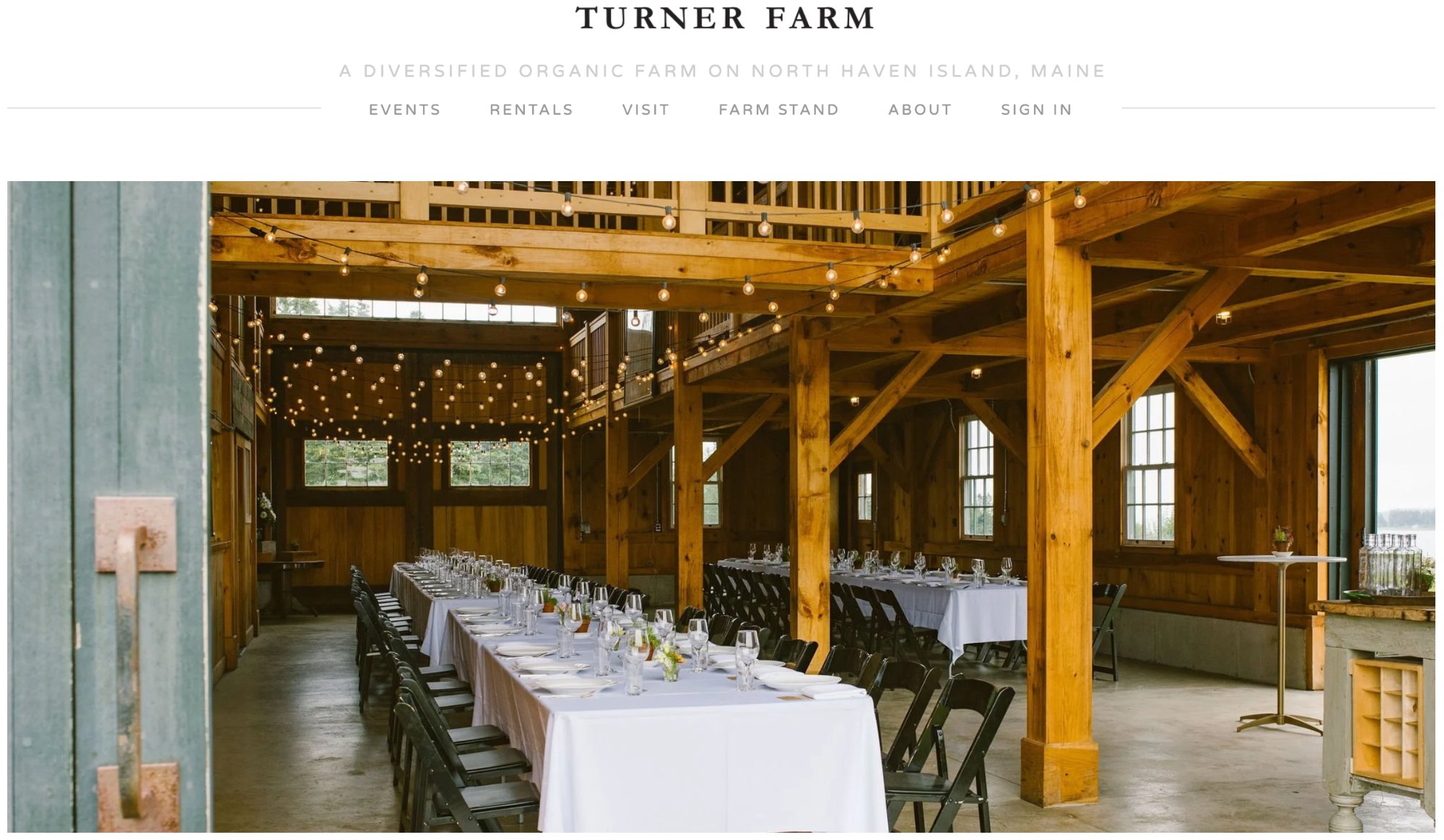 Turner Farm barn set for dinner · string lights overhead