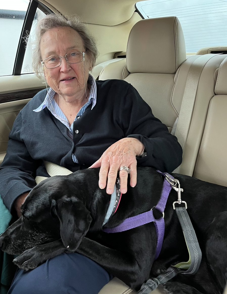 Diane Garcia with a black lab on the ferry